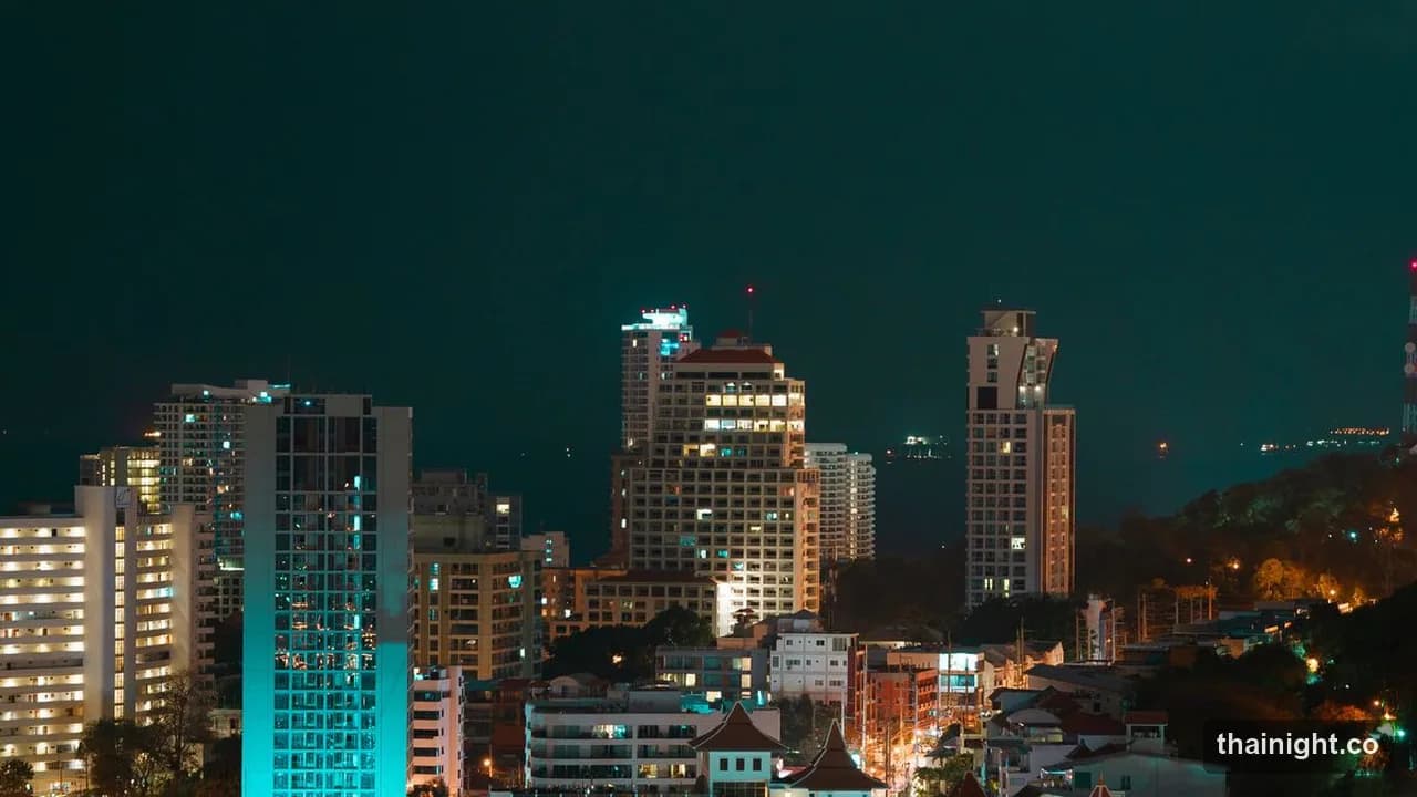 Pattaya hotel towers lit up at night above the bay