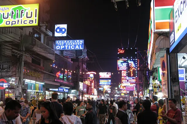Crowds on Walking Street, Pattaya, at night under shop and restaurant signs